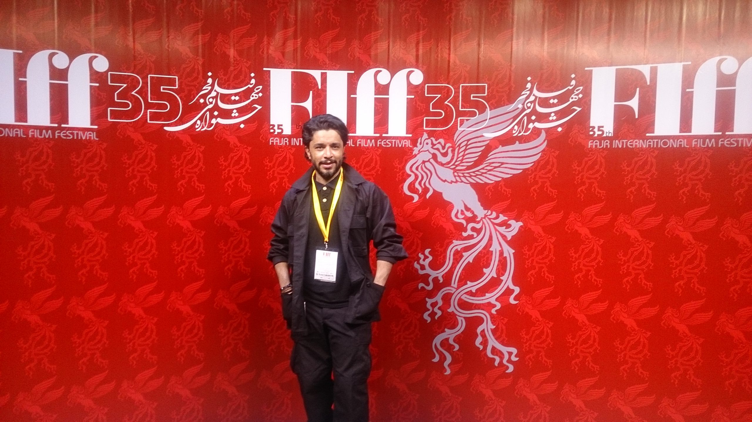 arash bahmani poses for press photographers on red carpet ceremony of fajr international film festival