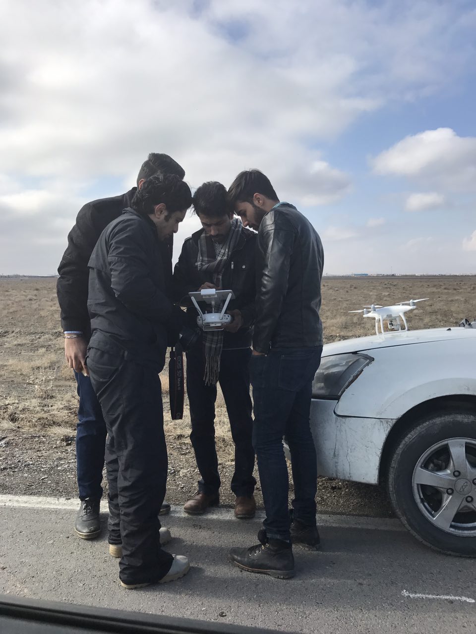 arash bahmani explaining a shooting scene for a drone pilot on scene