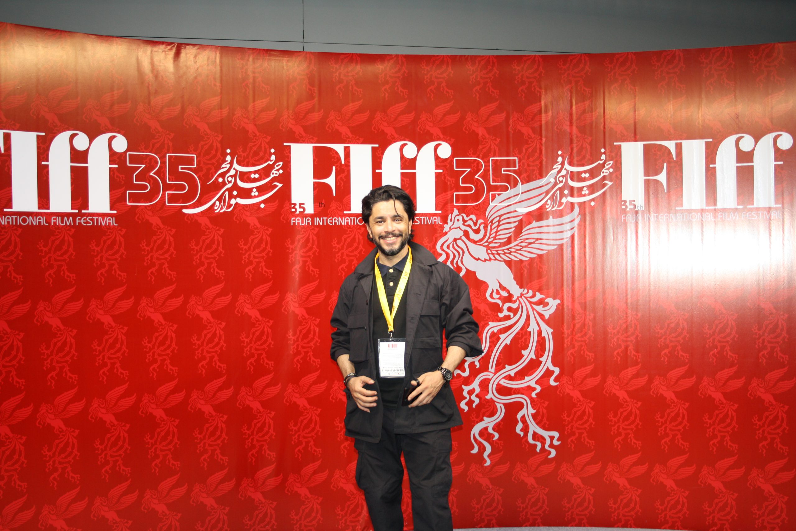 arash bahmani with a black coat on red carpet VIP section