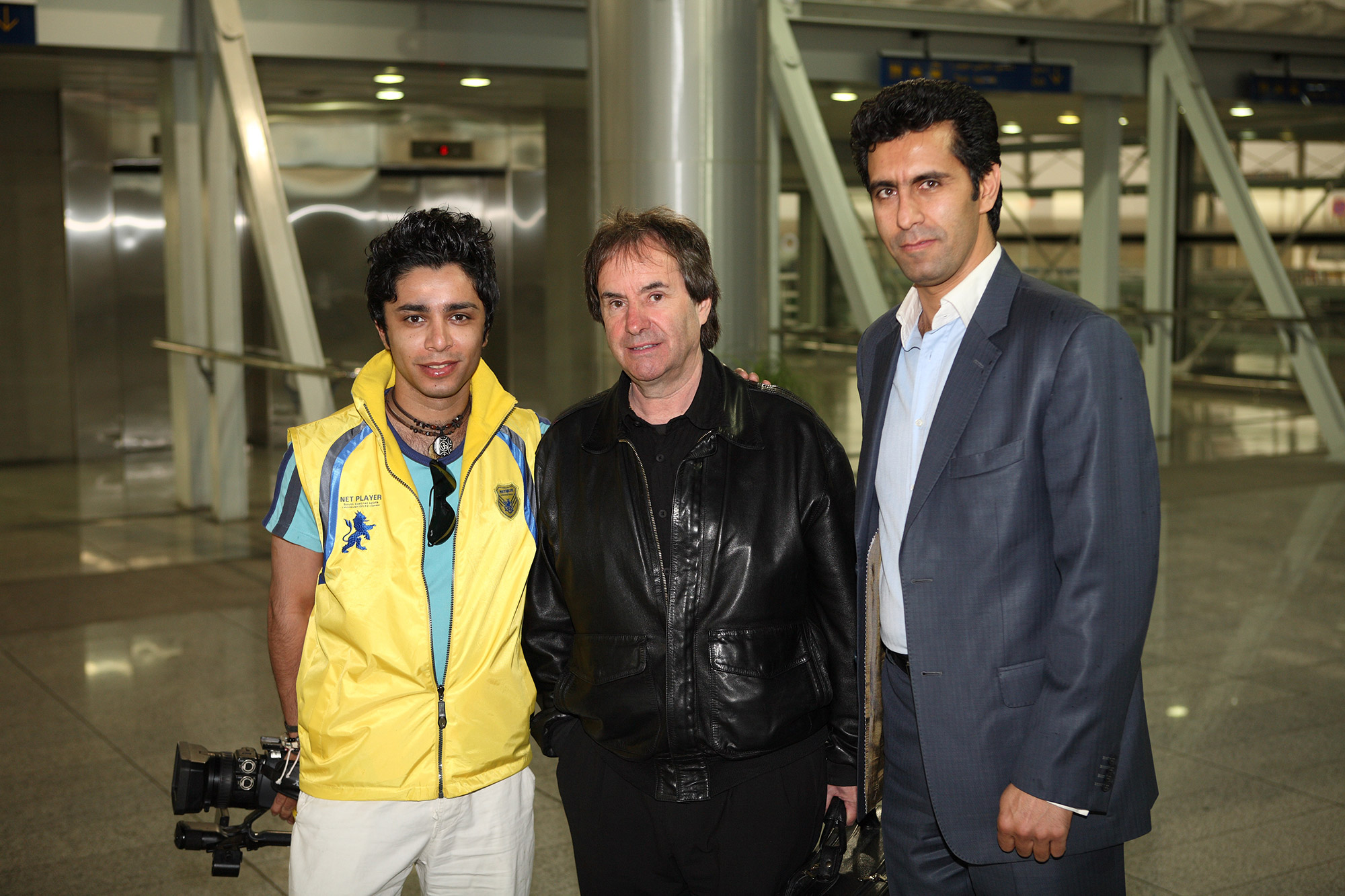 Behind the scenes of chris de burgh documentary film - arash bahmani with a yellow jacket holding a Sony video camera